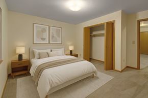 Stanley apartment for rent - A bedroom with a large bed and two lamps.