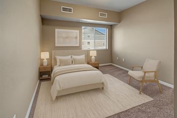 Williston apartment for rent - A bedroom with a large bed and a chair.