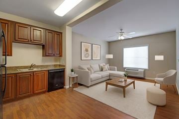 Williston apartment for rent - A modern kitchen with wooden cabinets and a white sofa.