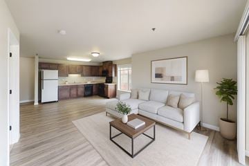 Williston apartment for rent - A living room with a white couch and a coffee table in the center.