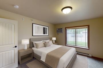 Williston apartment for rent - A bedroom with a large bed and a window.