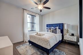 Edmond apartment for rent - A bedroom with a bed, nightstand, and window.