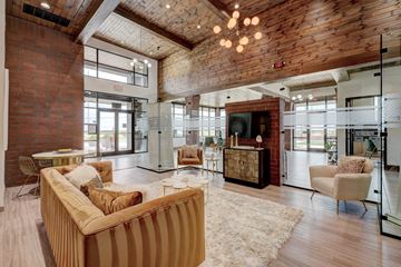 Edmond apartment for rent - A living room with a striped couch and a wooden ceiling.