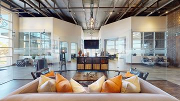 Owasso apartment for rent - A modern living room with a large couch and a television.