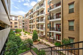 Oklahoma City apartment for rent - A view of a courtyard from a balcony of a building.