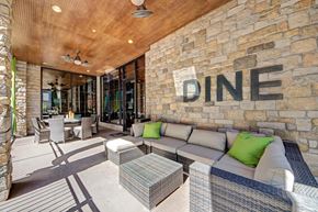 Tulsa apartment for rent - A dining area with a stone wall and a sign that says "DINE".
