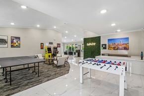 Oklahoma City apartment for rent - A foosball table is in the middle of a room with a ping pong table and a pool table.