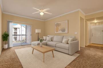 Tulsa apartment for rent - A living room with a grey couch, a wooden coffee table, and a painting on the wall.