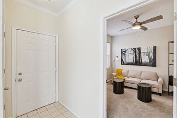 Oklahoma City apartment for rent - A living room with a white couch and a ceiling fan.