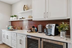 Oklahoma City apartment for rent - A kitchen with white cabinets and a brick backsplash.