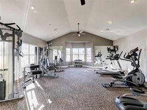 Oklahoma City apartment for rent - A spacious gym with a variety of equipment and a fan on the ceiling.