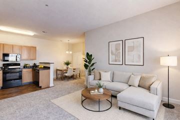 Oklahoma City apartment for rent - A modern living room with a white couch and a coffee table.