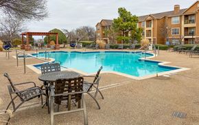Oklahoma City apartment for rent - A pool area with chairs and a table.