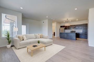 Oklahoma City apartment for rent - A modern living room with a white sofa and a wooden coffee table.