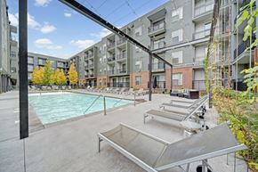 Oklahoma City apartment for rent - A pool area in a residential complex with a diving board.