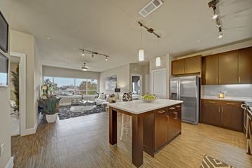Oklahoma City apartment for rent - A modern kitchen with wooden cabinets and a large island.