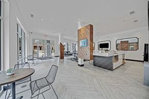 Oklahoma City apartment for rent - A modern office space with a reception desk and chairs.