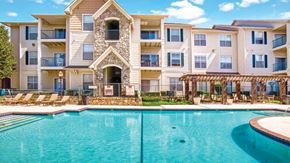 Broken Arrow apartment for rent - A large apartment complex with a pool in front.