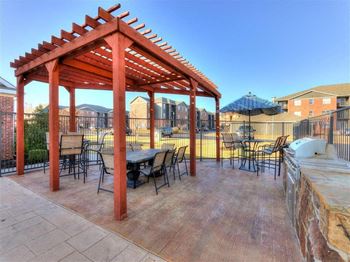 Gas grill and lounge next to pool