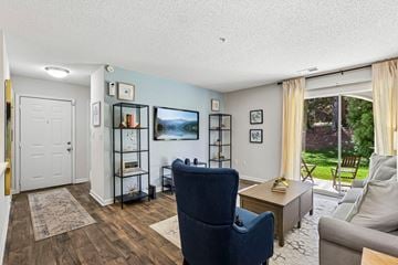 Fort Mill apartment for rent - A living room with a blue chair and a grey couch.