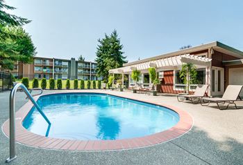 Outdoor pool with lounge chairs and pergola