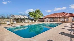 Midland apartment for rent - A swimming pool in a backyard with a patio and a gazebo.