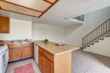 Midland apartment for rent - A kitchen with wooden cabinets and a stove top oven.