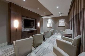 Dallas apartment for rent - A modern living room with a grey carpet and beige chairs.
