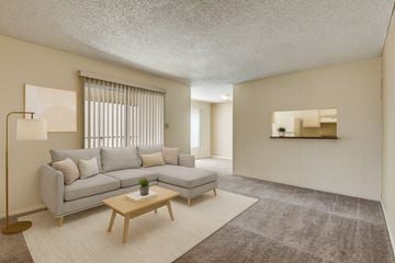 Odessa apartment for rent - A living room with a grey sofa and a wooden coffee table.