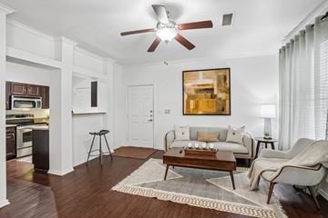 Fort Worth apartment for rent - A living room with a brown rug and a brown coffee table.