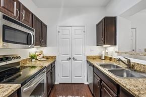 Fort Worth apartment for rent - A kitchen with brown cabinets and a white door.