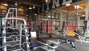 Fort Worth apartment for rent - A gym with a variety of equipment including weights and benches.