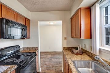 Odessa apartment for rent - A kitchen with a black microwave above the stove.