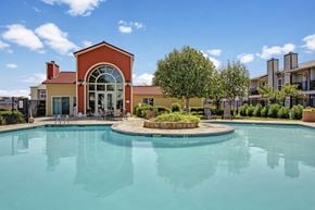 Odessa apartment for rent - A resort-style swimming pool here at High Plains with clear blue water, surrounding lounge chairs, and a landscaped courtyard, complemented by a clubhouse building and bright skies that create a relaxing, inviting outdoor setting.