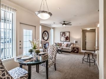 Midland apartment for rent - A well-lit living room with a dining table set for two.
