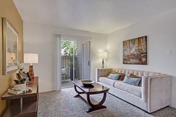 Midland apartment for rent - A living room with a couch, coffee table, and a painting on the wall.