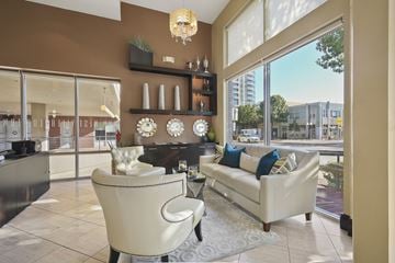 Dallas apartment for rent - A living room with a white chair and a white couch.