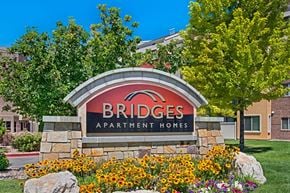 Salt Lake City apartment for rent - A sign for Bridges Apartment Homes is in front of a building.