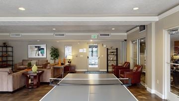 Salt Lake City apartment for rent - A ping pong table is in the middle of a living room.