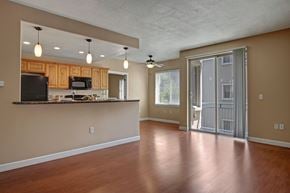 Salt Lake City apartment for rent - A kitchen with wooden cabinets and a countertop with a microwave and oven.