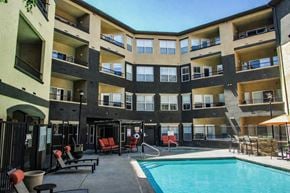 Salt Lake City apartment for rent - A large apartment complex with a pool and patio area.