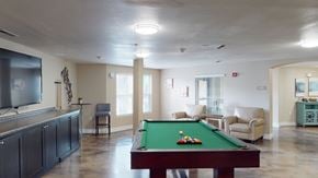 Salt Lake City apartment for rent - A pool table with a green cloth and white balls is in the center of the room.