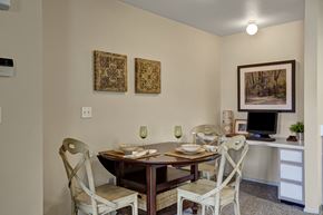 Sandy apartment for rent - A dining room with a table set for two and two chairs.