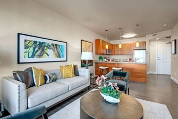Salt Lake City apartment for rent - A living room with a couch, coffee table, and a painting on the wall.