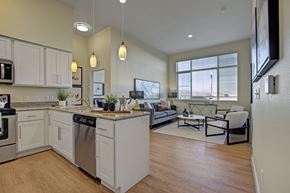Salt Lake City apartment for rent - A modern kitchen with white cabinets and a large island.