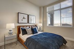 Salt Lake City apartment for rent - A bedroom with a large bed and two lamps.