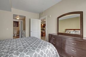 Salt Lake City apartment for rent - A bedroom with a bed, dresser and mirror.