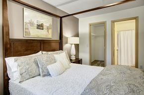 Covington apartment for rent - A bedroom with a large bed and a painting on the wall.