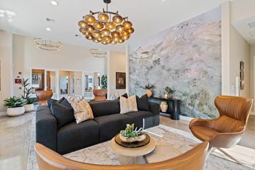 Leavenworth apartment for rent - A living room with a grey sofa and a brown armchair.