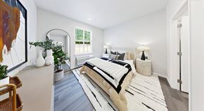 Leavenworth apartment for rent - A bedroom with a large bed and a painting on the wall.